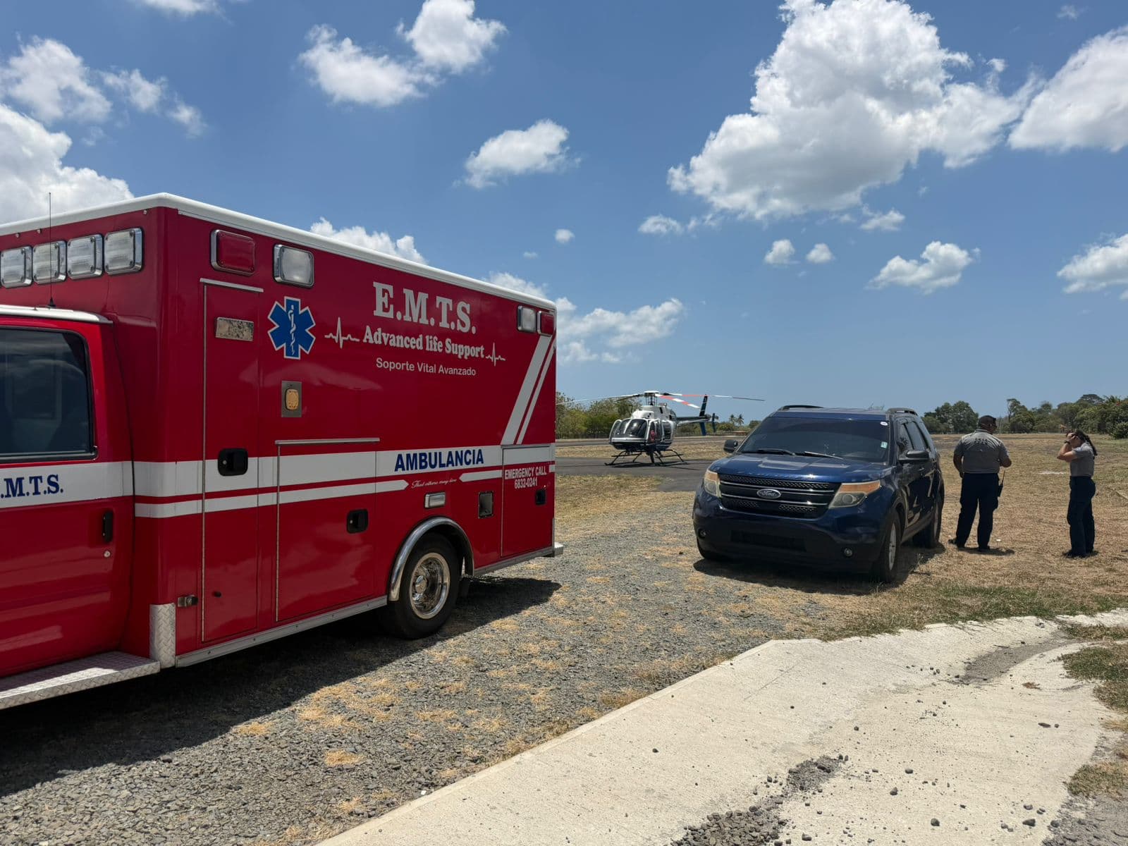 An EMTS ambulance alongside the partner Bell 407 helicopter at a landing zone
