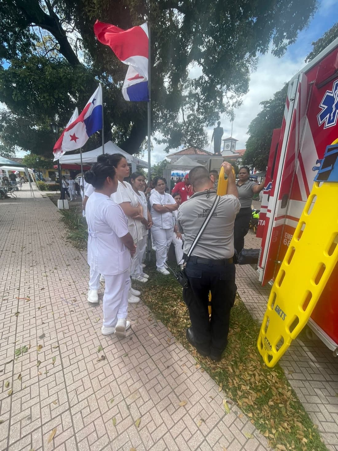 EMTS crew and equipment at a public health event alongside nurses and other services