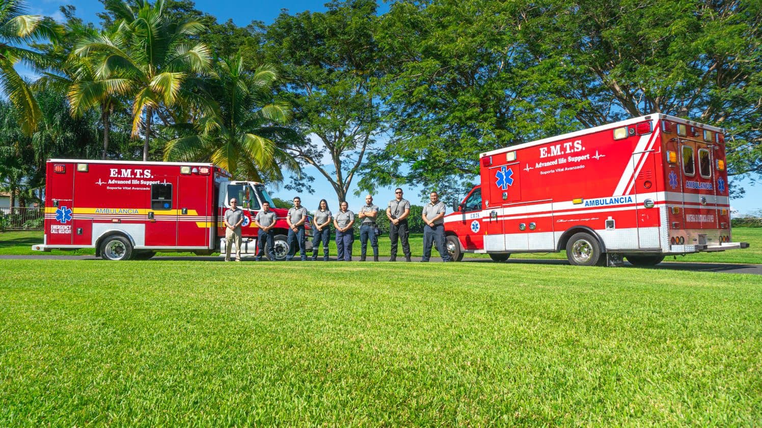 The EMTS crew lined up between two advanced life support ambulances